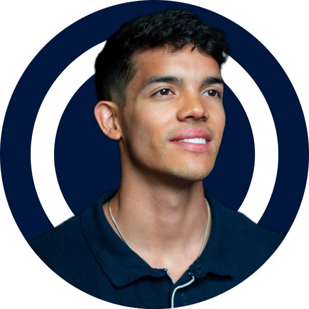 Scale Your Content Agency With Julian Corzo A young man with short hair, smiling and looking to the side, with a dark blue background encircled by two white rings, poised ready to Conquer Acquisitions. Conquer Acquisitions